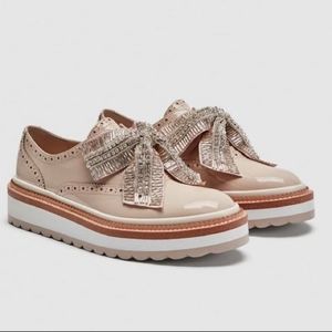 Nude Platform Oxfords with removable silver bows.